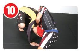 Now Garry picks a side and slides his right arm deeper under his opponent’s neck while bringing his right thigh up along the head. While doing this movement, Garry’s also dropping his head to his opponent’s left shoulder and his left elbow is up high with his hands clasped. The trick here is not the arm position, but the rotation of Garry’s body. The placement of the knee prevents the other guy’s head from popping out when Garry rotates for the finish.