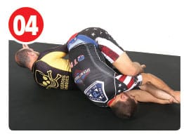 Garry begins his roll by tucking his head and rolling his right shoulder to the mat. Little tip here, Garry always reaches for the feet so he knows which way to roll.