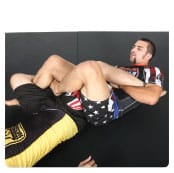 B. Garry pivots to the side of the target leg, while threading his left leg through his opponent’s legs creating a figure 4.