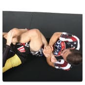 C. He turns his body to the heel, bending his left arm to hook the heel. Then he finishes twisting his body away to bring his opponent’s heel upward and to the right.