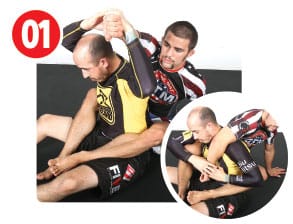 Garry has the back, hooks in with a seat belt. A common defense for his opponent is to lift the arm that’s over the shoulder and sneak the head out to escape a choke. When his opponent does this, Garry goes with it.