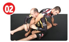 Garry wants to grab his own right knee with his right hand after the neck escape. To do this, Gary posts his left hand to the mat twisting a bit so he can feed his right knee to his right hand.