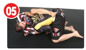 Garry brings his left leg over to hug the back and finishes with a normal head and arm guillotine.