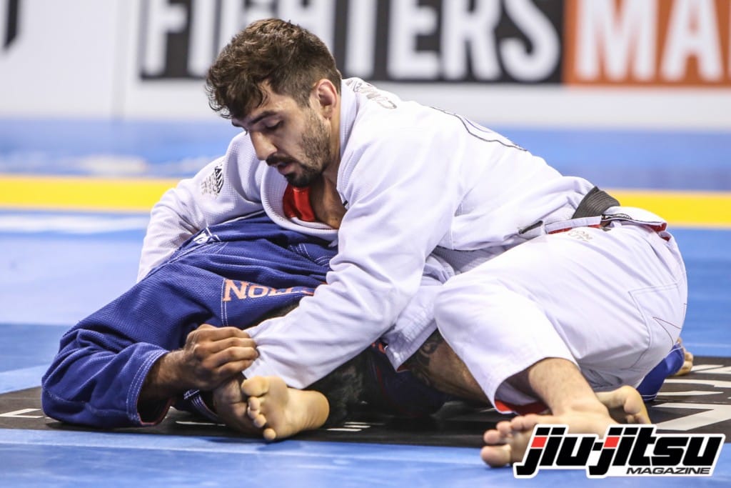 Lucas Lepri teaches a clock choke after taking the back from the sitting guard